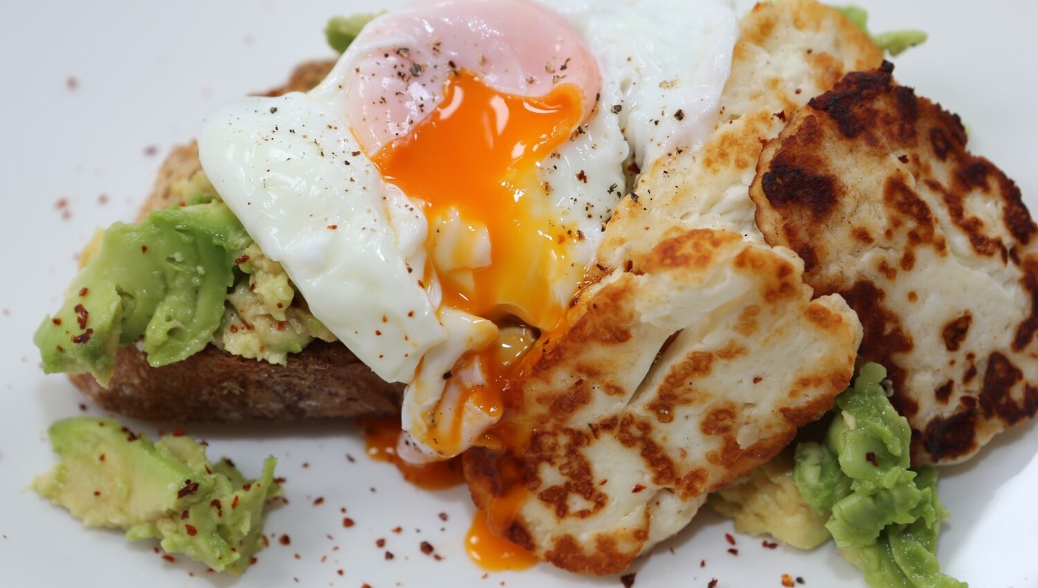 Smashed avocado, poached egg and grilled halloumi on toasted sourdough